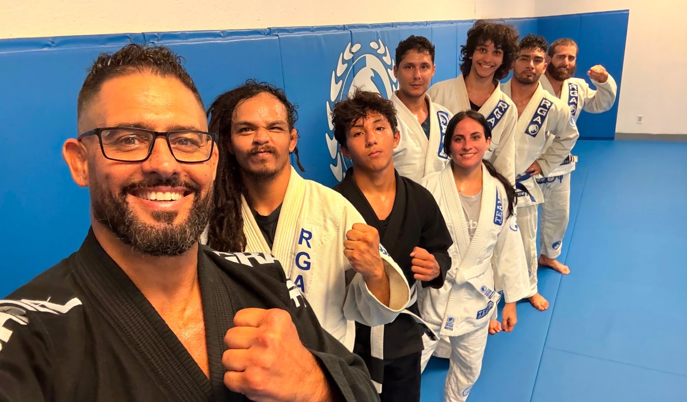 Renzo Gracie Naples adult members together on the mat after class