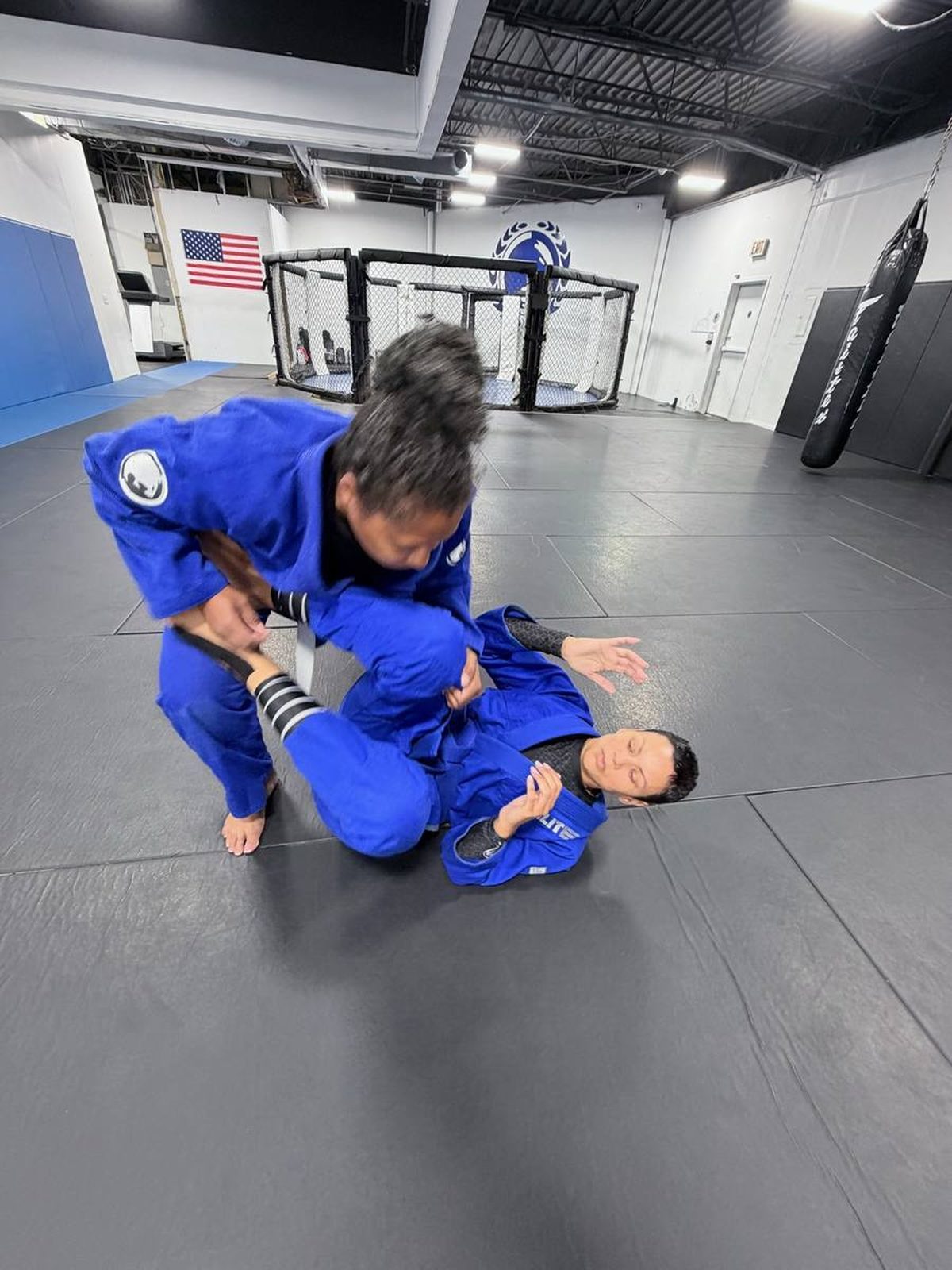 Students practicing guard passing on the mat
