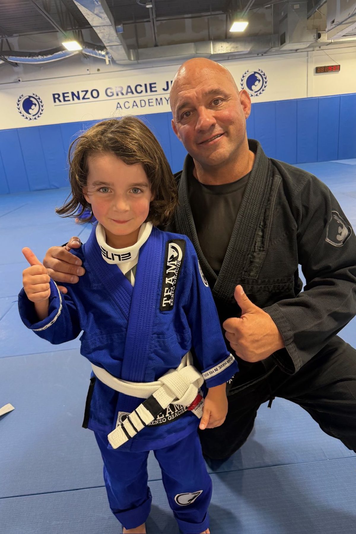 Professor Mark Cerrone with a young student after a belt promotion